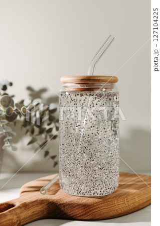 Chia water in a glass on a kitchen wooden board. Healthy detox drink. Chia water in a glass on a kitchen wooden board. Healthy detox drink. 127104225