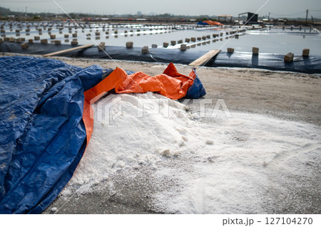 Harvested sea salt. Salt heap after evaporation at production site near village, manual collection 127104270