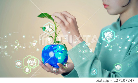 植物の生えた地球を持つ女の子　環境コンセプトビジュアル 127107247