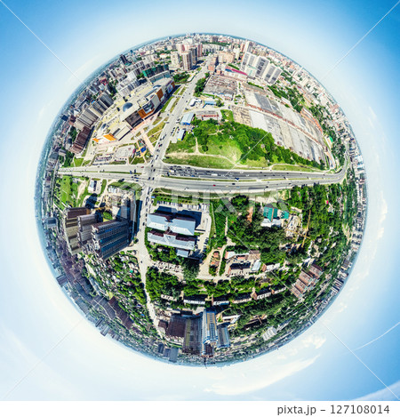 Aerial city view with crossroads and roads, houses, buildings, parks and parking lots. Sunny summer panoramic image 127108014