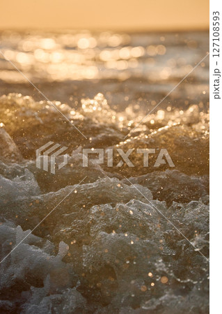 Seething water from under a boat at sunset Seething water from under a boat at sunset 127108593