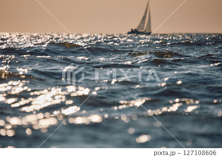 Sailing regatta in the Gulf of Finland at sunset, sailing yacht competing in a race, splashing water from under the boat, teamwork, board the boat 127108606