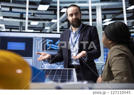 Photovoltaics factory businessmen discussing upgrades to make to improve sales. Solar panels manufacturing plant managers brainstorming ways to reduce downtime and increase production Photovoltaics factory businessmen discussing upgrades to make to improve sales. Solar panels manufacturing plant managers brainstorming ways to reduce downtime and increase production 127110545