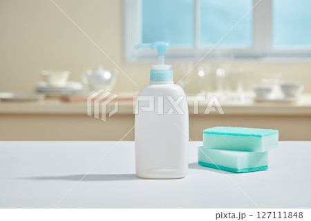 A bright blue sponge and pump bottle on a smooth kitchen surface with soft reflections and tidy surroundings evoking cleanliness. A bright blue sponge and pump bottle on a smooth kitchen surface with soft reflections and tidy surroundings evoking cleanliness. 127111848