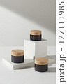 Cosmetics advertising scene with minimalist concept. Three cosmetic jars no label displayed on white podium on a white background. Mock up packaging, cosmetics design 127111985