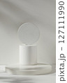 Pedestal for cosmetic product and packaging mockups display presentation. Three geometries podiums decorated on white background with shadow leaf 127111990