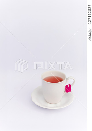 Relaxing concept hot herbal tea in white mug on white background 127112827