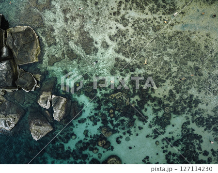 Aerial View of Tropical Bay with Crystal Clear Turquoise Water and Swimmers 127114230