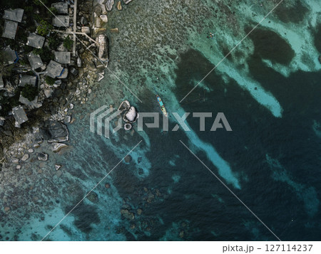 Aerial View of Tropical Bay with Crystal Clear Turquoise Water and Swimmers 127114237