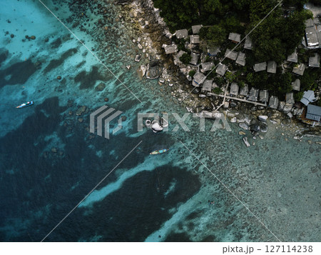 Aerial View of Tropical Bay with Crystal Clear Turquoise Water and Swimmers 127114238