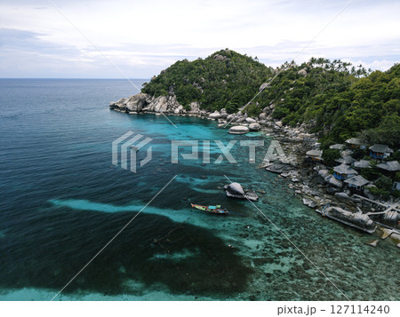 Vibrant Thai Longtail Boat in Turquoise Waters by Tropical Beach and Lush Mountains Vibrant Thai Longtail Boat in Turquoise Waters by Tropical Beach and Lush Mountains 127114240
