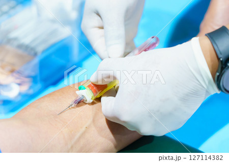 Close up hand collecting blood sample for diagnosis and treatment patient in the hospital.Laboratory technician taking blood for blood chemistry analysis 127114382