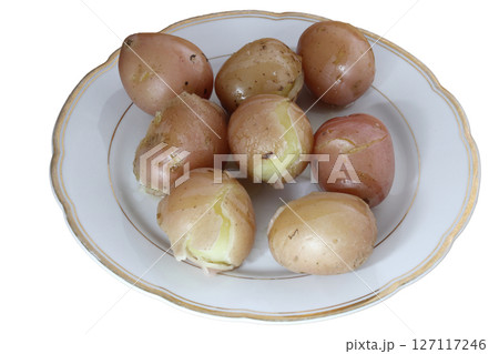 Boiled unpeeled potatoes on a porcelain plate. Boiled unpeeled potatoes on a porcelain plate. 127117246
