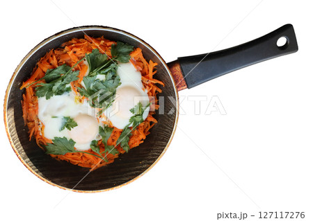 Fried eggs with grated carrots and parsley. 127117276
