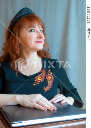 modern woman with elements of ethno-style in a costume uses the technique 127118814