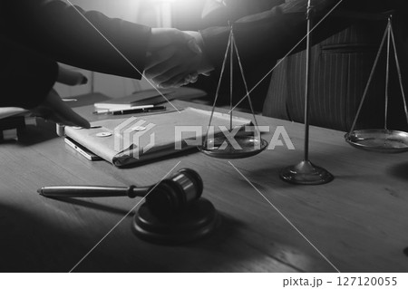 Attractive young lawyer in office Business woman and lawyers discussing contract papers with brass scale on wooden desk in office. Law, legal services, advice, Justice and real estate concept. 127120055