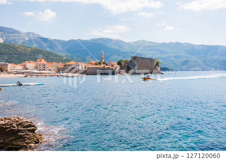 Old coastal town with historic fortress and vibrant seaside life in Montenegro, Budva. Adriatic architecture, tourism, and Mediterranean cultural heritage. Old coastal town with historic fortress and vibrant seaside life in Montenegro, Budva. Adriatic architecture, tourism, and Mediterranean cultural heritage. 127120060