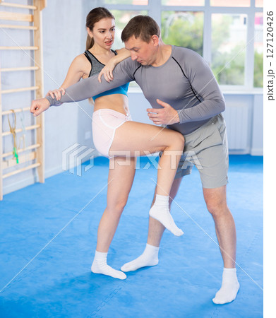 Woman and man practicing self defense techniques 127120426