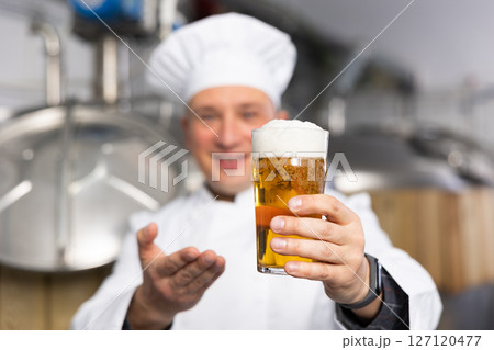 Man brewmaster with glass of beer 127120477