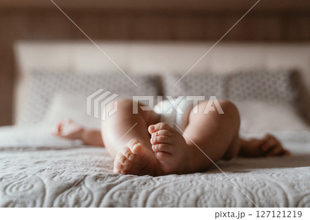 Peaceful Baby Sleeping on Comfortable Bed 127121219