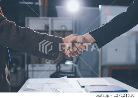 Two businessmen shaking hands after reaching agreement in office Two businessmen shaking hands after reaching agreement in office 127121510