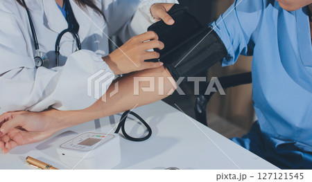 Doctor checking patient arterial blood pressure in hospital. Health care Concept 127121545