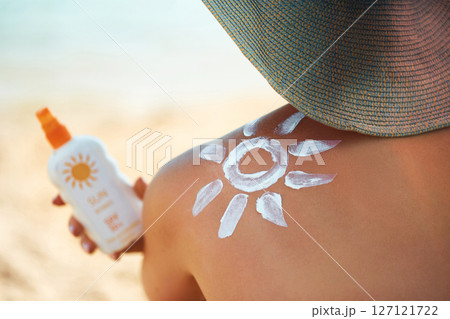 Sun cream on tanned shoulder with sun shape . Sun protection. Beautiful woman in bikini applying Solar Cream. Skin and body care.Portrait of female holding suntan lotion Sun cream on tanned shoulder with sun shape . Sun protection. Beautiful woman in bikini applying Solar Cream. Skin and body care.Portrait of female holding suntan lotion 127121722