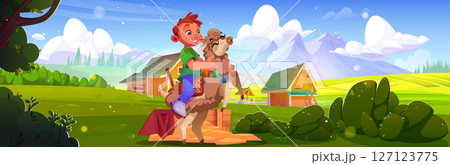 Happy boy rides llama on farm landscape 127123775
