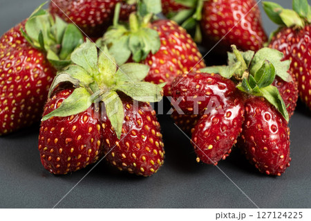Fresh strawberries with an unusual shape close-up 127124225