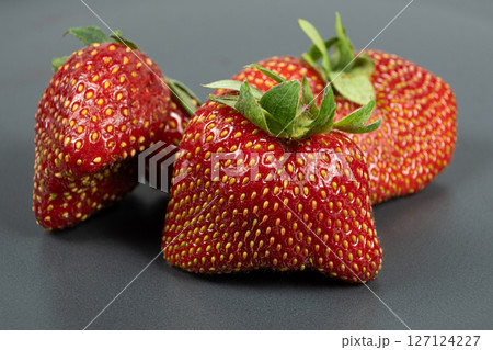 Fresh strawberries with an unusual shape close-up Fresh strawberries with an unusual shape close-up 127124227