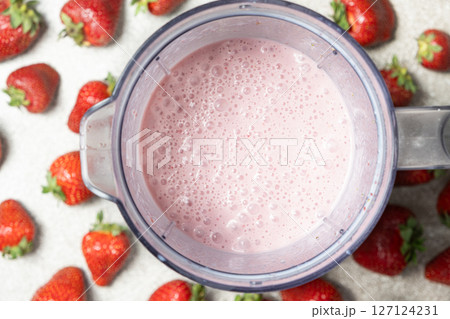 Strawberry milkshake freshly prepared in a blender bowl, top view Strawberry milkshake freshly prepared in a blender bowl, top view 127124231
