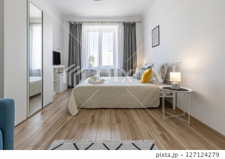 Full View of Cozy Modern Bedroom Interior with Decorated Bed Full View of Cozy Modern Bedroom Interior with Decorated Bed 127124279