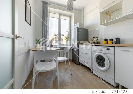 Full Modern Kitchen with Dining Area and Window Light 127124283
