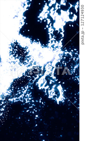 Blurred abstract composition of bright blue light splashes and glowing streaks forming a wave on dark background Blurred abstract composition of bright blue light splashes and glowing streaks forming a wave on dark background 127124930