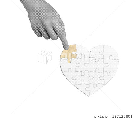 Hand holding a golden heart puzzle piece, symbolizing love, unity, and connection. The piece 127125801