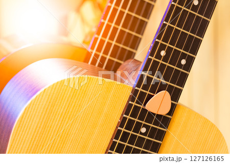 close up pink pick on acoustic guitar, music background 127126165