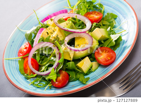Salad of arugula with avocado 127127889