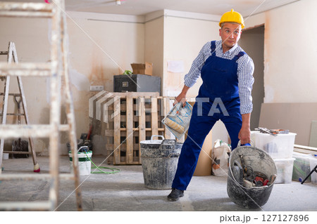 Man builder working in construction site 127127896