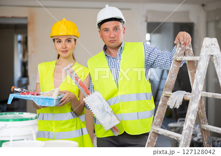 Portrait of man and woman builders with tools Portrait of man and woman builders with tools 127128042