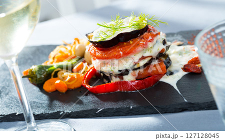 Grilled eggplants with tomatoes 127128045