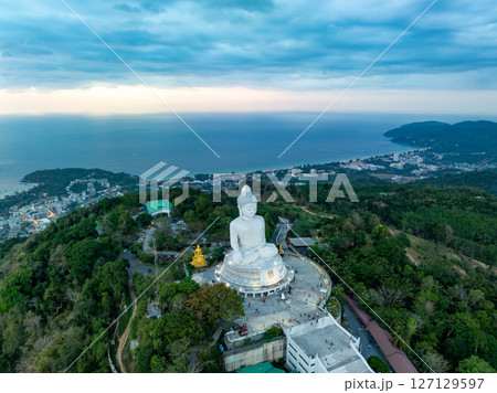 Aerial View drone shot of Big Buddha Statue on the high mountain at Phuket thailand in evening time. 127129597