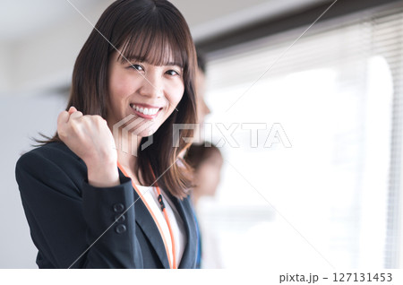 ガッツポーズする若いスーツ姿の女性 127131453