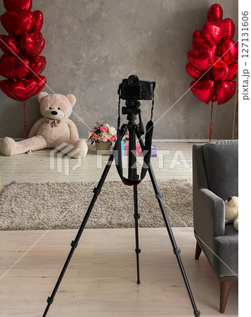 Camera on a tripod in a photo studio with balloons Camera on a tripod in a photo studio with balloons 127131606