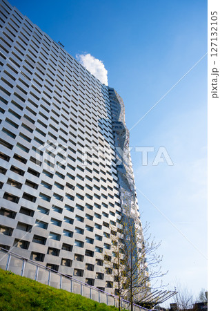Visitors challenge themselves on the tallest climbing wall globally at Amager Bakke in Copenhagen, Denmark. The wall stands tall against a clear blue sky, offering endless climbing opportunities. Visitors challenge themselves on the tallest climbing wall globally at Amager Bakke in Copenhagen, Denmark. The wall stands tall against a clear blue sky, offering endless climbing opportunities. 127132105
