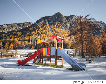 Vibrant playground nestled among snow peaked mountains and golden autumn trees in scenic aosta valley, northern italy Frazionne Lillaz Vibrant playground nestled among snow peaked mountains and golden autumn trees in scenic aosta valley, northern italy Frazionne Lillaz 127132451
