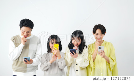 スマホを持って笑顔で考える女の子家族 127132874