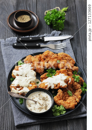 Deep fried Southern chicken thighs with milk gravy 127133669
