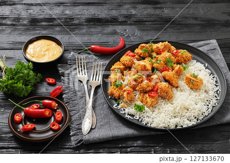 panko-breaded chicken bites with rice and sauce 127133670