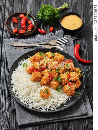 panko-breaded chicken bites with rice and sauce 127133671