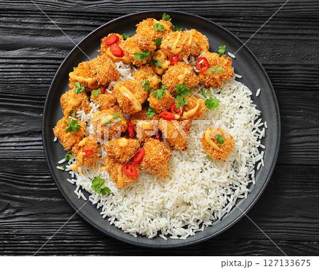 panko-breaded chicken bites with rice and sauce 127133675